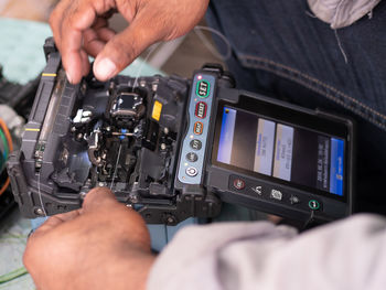 Midsection of person using mobile phone