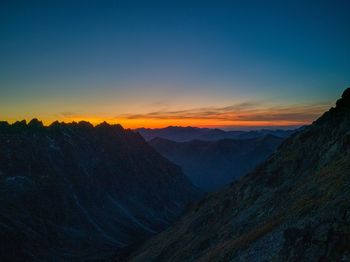 Scenic view of mountains against sky at sunset