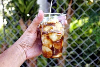 Close-up of hand holding drink