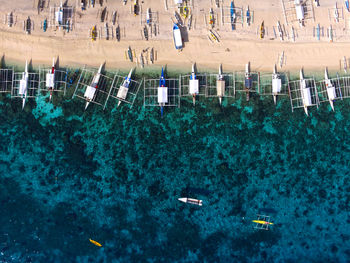 High angle view of boats moored at beach and sea