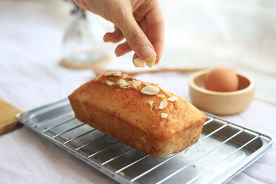 Cropped hand of person preparing food