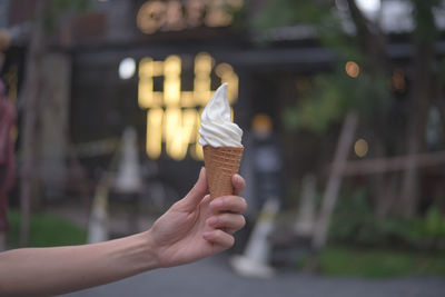 Cropped hand of woman holding ice cream cone