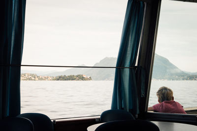 Rear view of boy sitting in boat