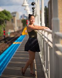 Young woman standing on station platform