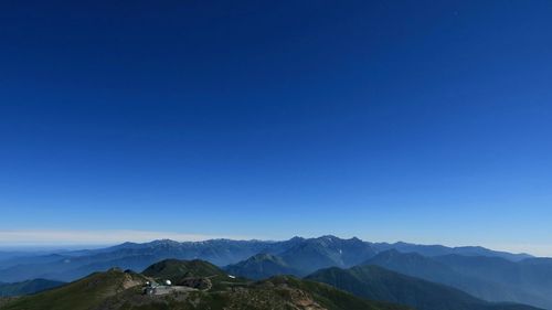 Scenic view of mountains against clear blue sky