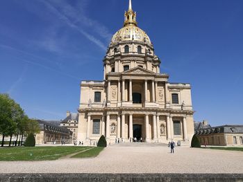 Facade of historic building against blue sky during summer