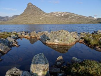 Scenic view of lake and mountains against sky