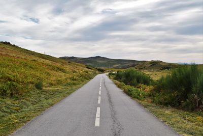 Empty road along countryside landscape