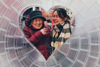 Portrait of smiling young woman with umbrella