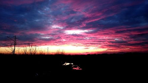 Silhouette of landscape against cloudy sky