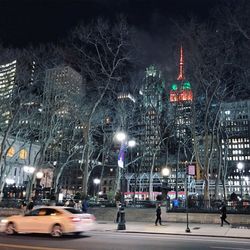 Illuminated christmas tree in city at night