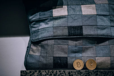 Close-up of coins by bag on table