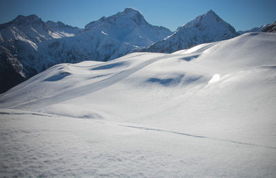 Scenic view of snow covered mountains against sky