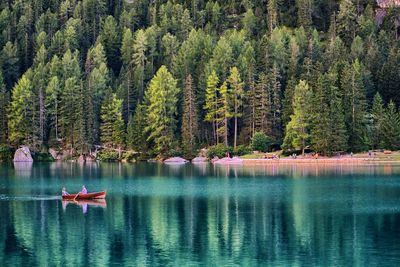 Man and woman sailing boat in lake