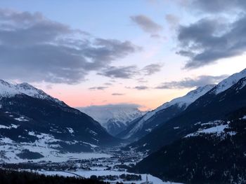 Scenic view of snowcapped mountains against sky during sunset