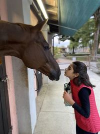 Side view of woman with horse