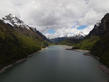 Scenic view of lake amidst mountains against sky