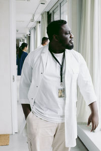 Young male doctor walking at hospital corridor