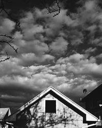 Low angle view of building against cloudy sky