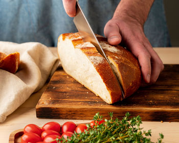 Close-up of person preparing food on cutting board