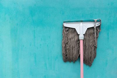 Mop on blue wall