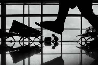 Low section of silhouette people at airport