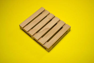 High angle view of piano on yellow background