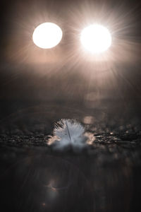 Close-up of illuminated lights against sky during sunset