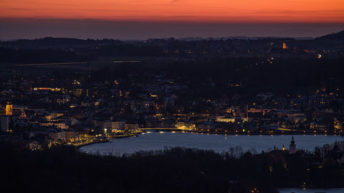 High angle view of illuminated buildings in city at sunset