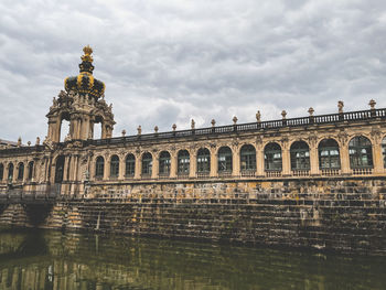 Low angle view of building against cloudy sky