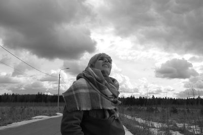 Woman standing on field against sky