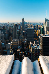 View of cityscape against clear sky during winter