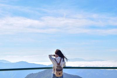 Woman standing in water against sky