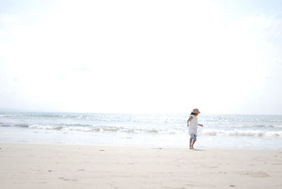 Woman on beach against sky