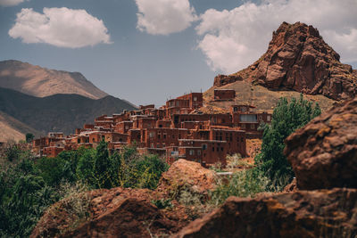 Panoramic view of buildings and mountains against sky