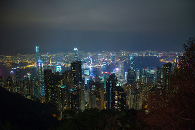 High angle view of illuminated buildings against sky at night