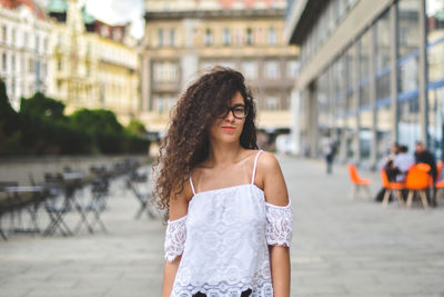 Portrait of beautiful young woman standing outdoors