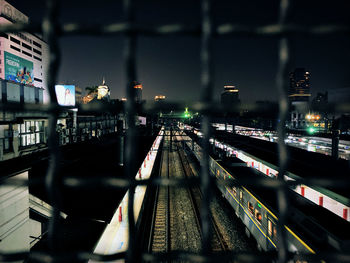 Train in city against sky at night