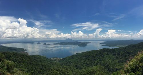 Panoramic shot of countryside lake against blue sky