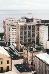 High angle view of buildings by sea against sky