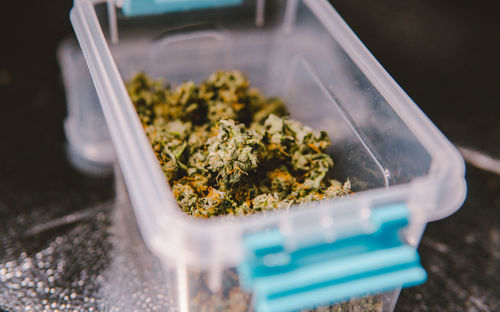 Close-up of cigarette in container on table