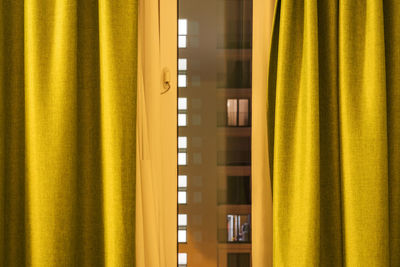 Curtain hanging by window at home