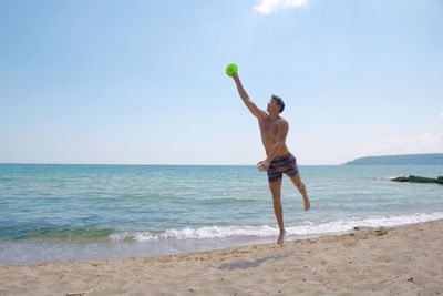 Full length of man standing on beach