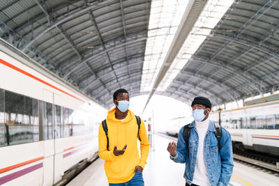 Man standing on railroad station platform