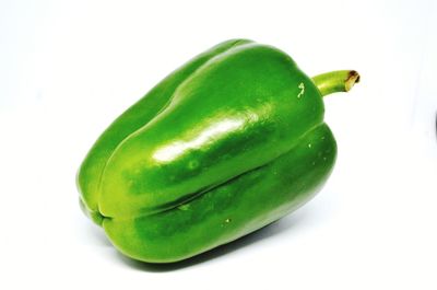 Close-up of green chili pepper over white background