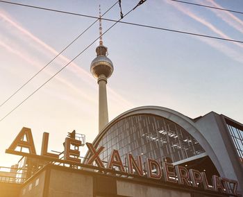 Low angle view of alexanderplatz train station with the television tower against sky