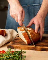 Close-up of man preparing food on cutting board