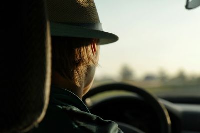 Rear view of man driving car