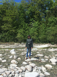 Man standing on rock against plants