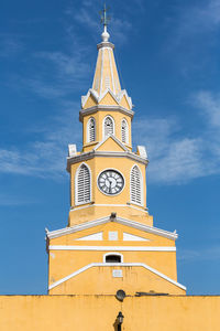 Low angle view of clock tower against sky